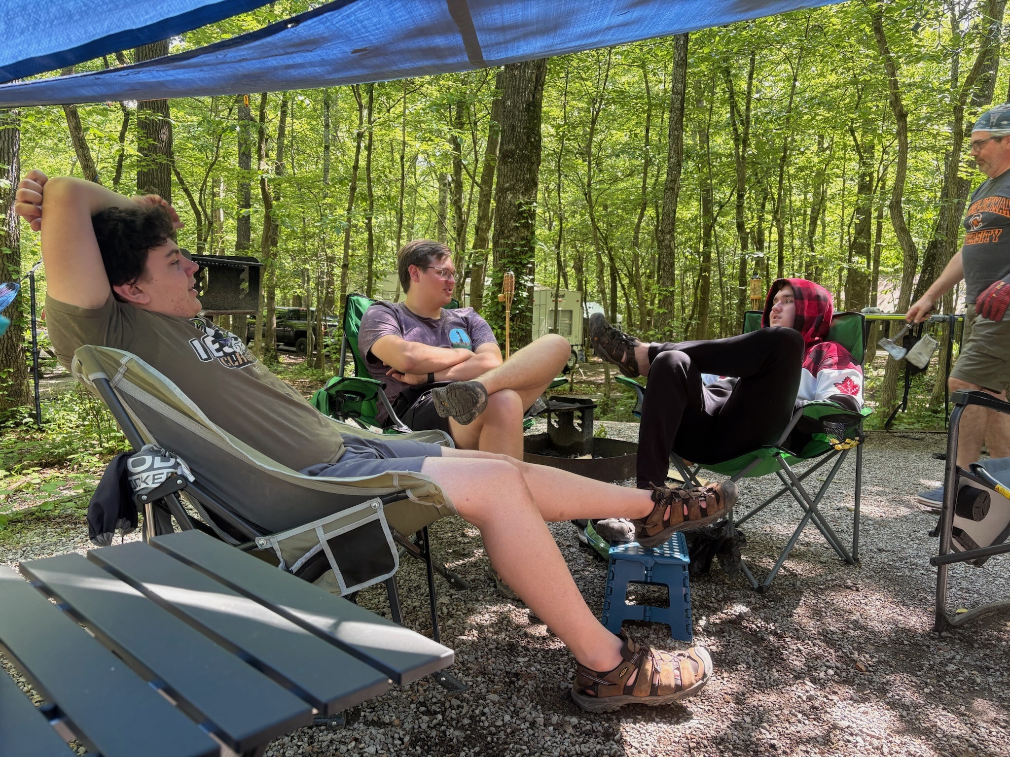 2025 FCF Lara 18 Three boys lounge in the campsite